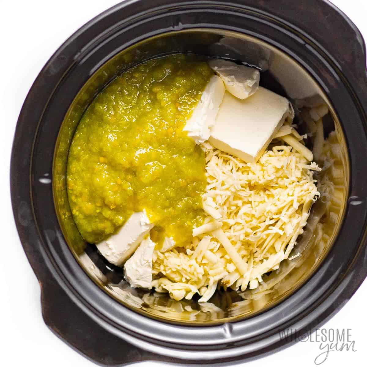 Queso dip ingredients in slow cooker
