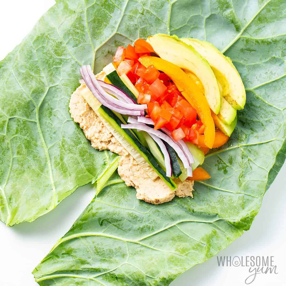 Toppings piled into a collard green leaf with a V cut out at the bottom.