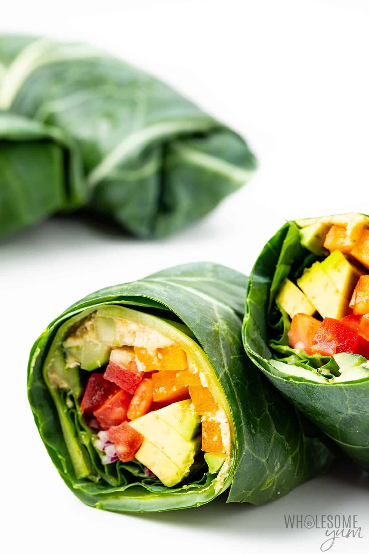 Colorful collard green wraps piled together.