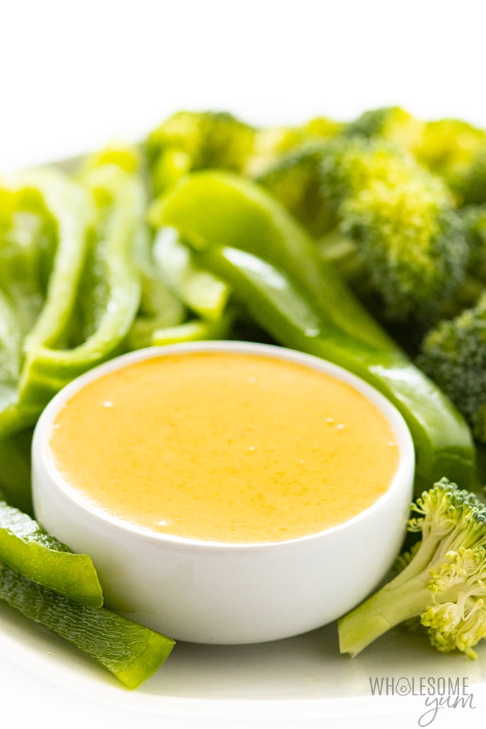 dish of keto cheddar cheese sauce with peppers and broccoli