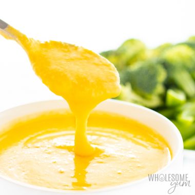 Keto cheese sauce for broccoli coming off a spoon