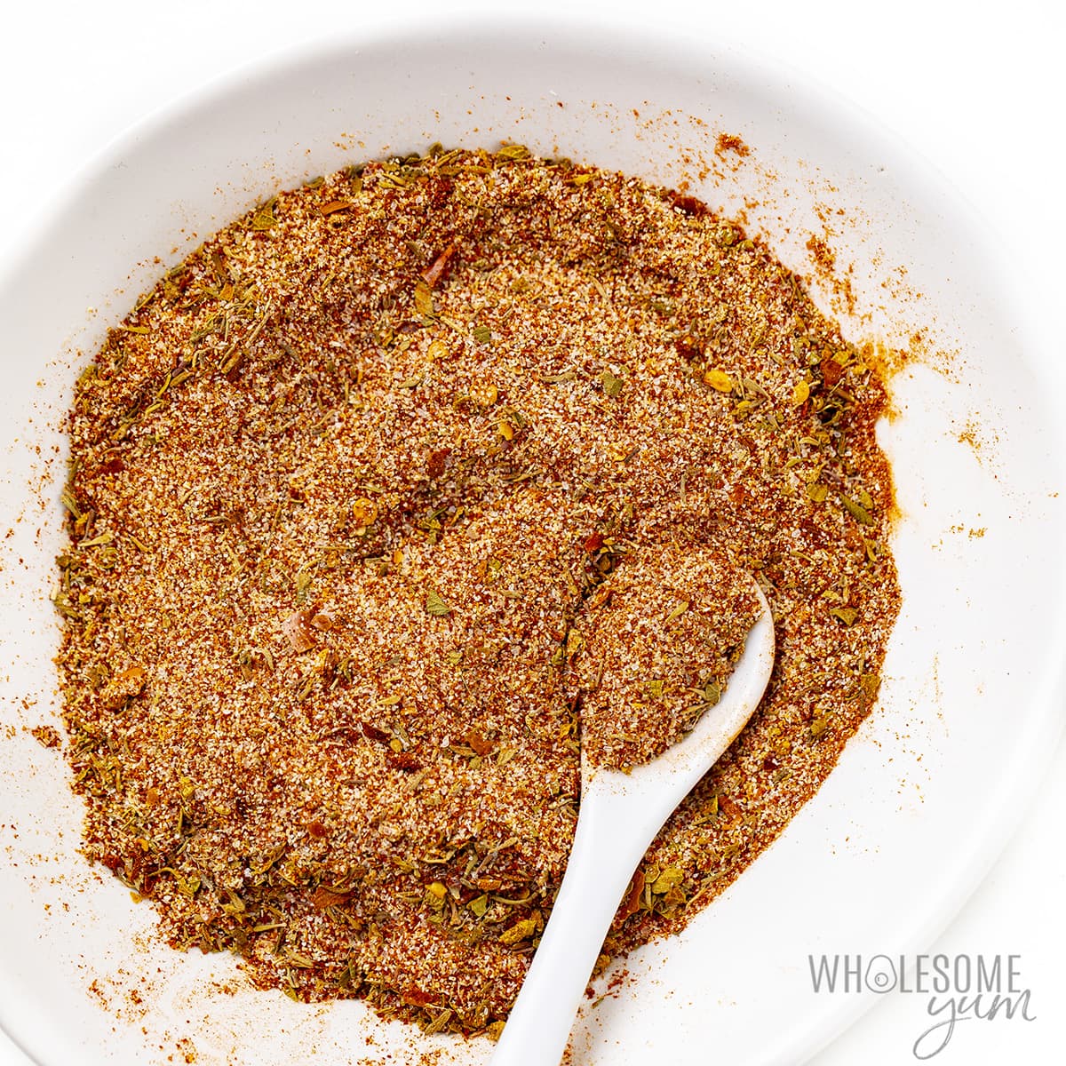 Spices mixed together with a spoon.