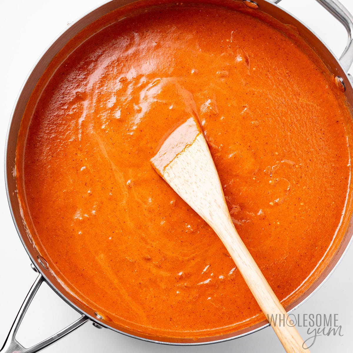 Butter chicken sauce mixed in the skillet.