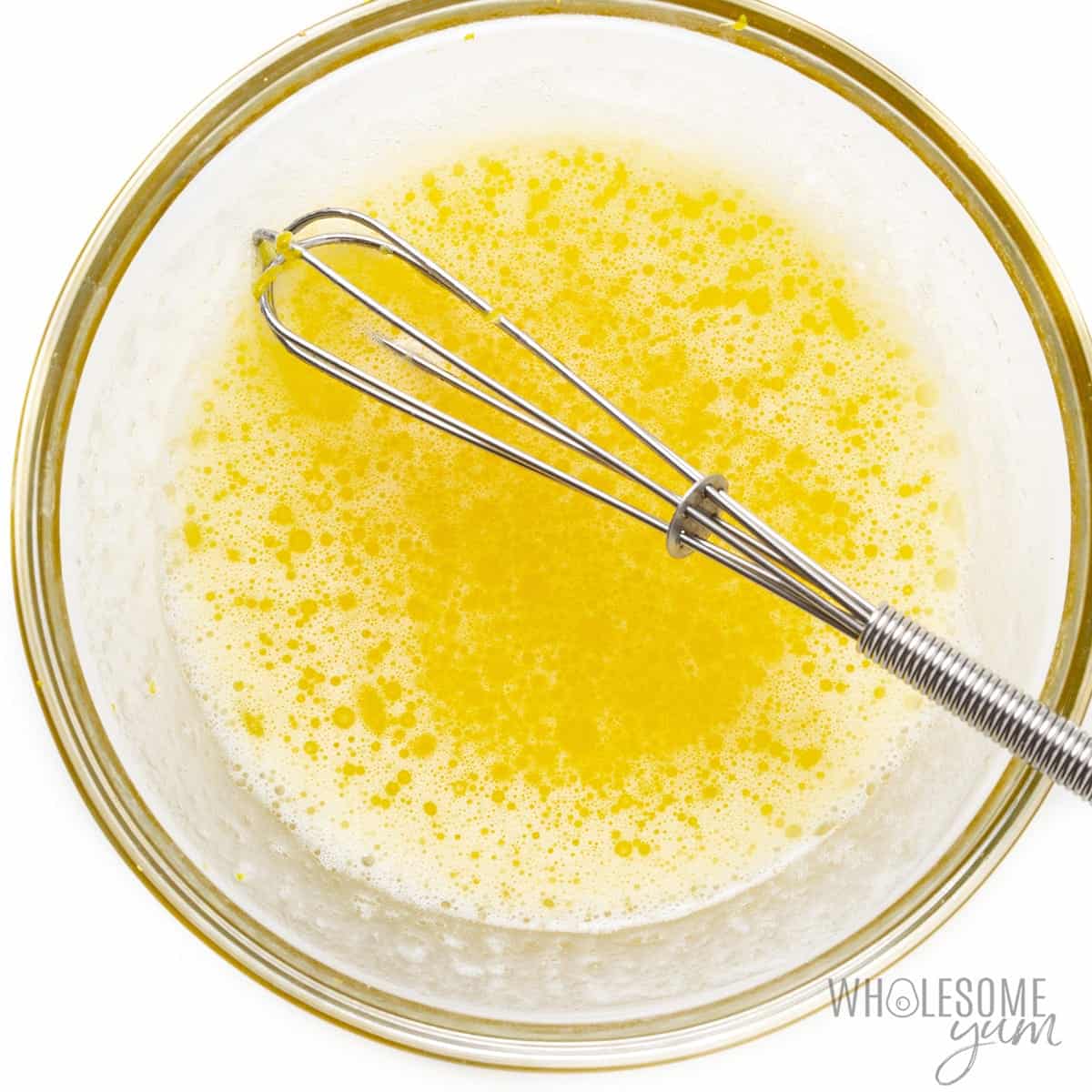 Lemon butter sauce in a bowl with whisk