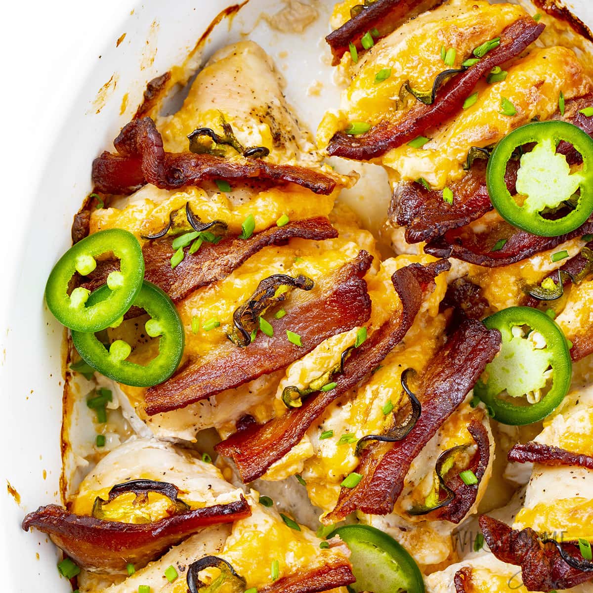 Hasselback chicken (jalapeno popper style) in baking dish.
