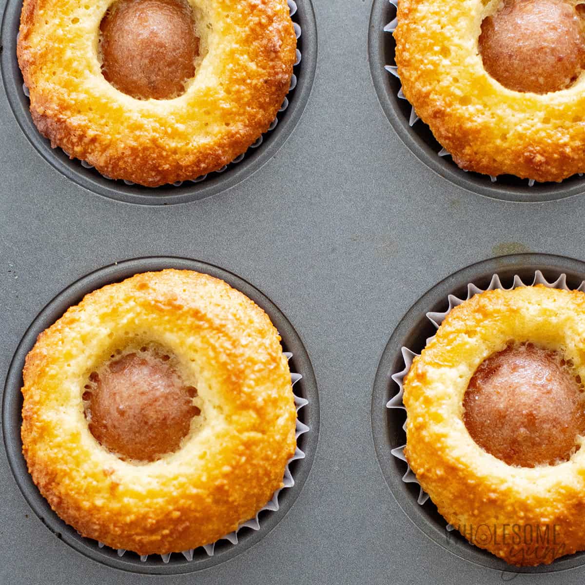 Healthy corn dogs in a muffin tin.