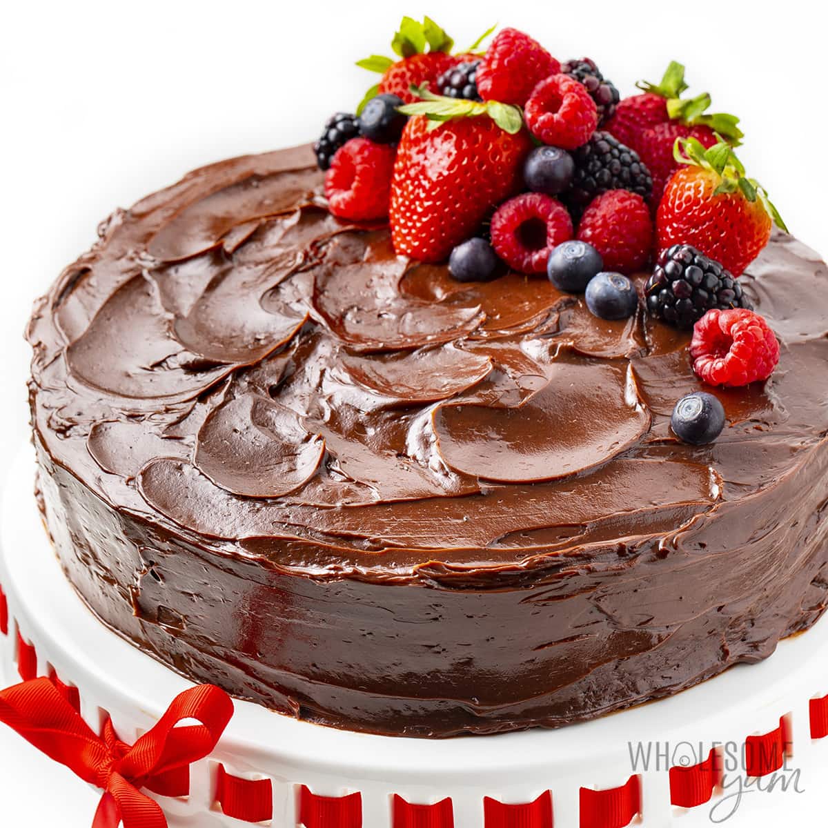 Decorated keto chocolate cake recipe with berries.