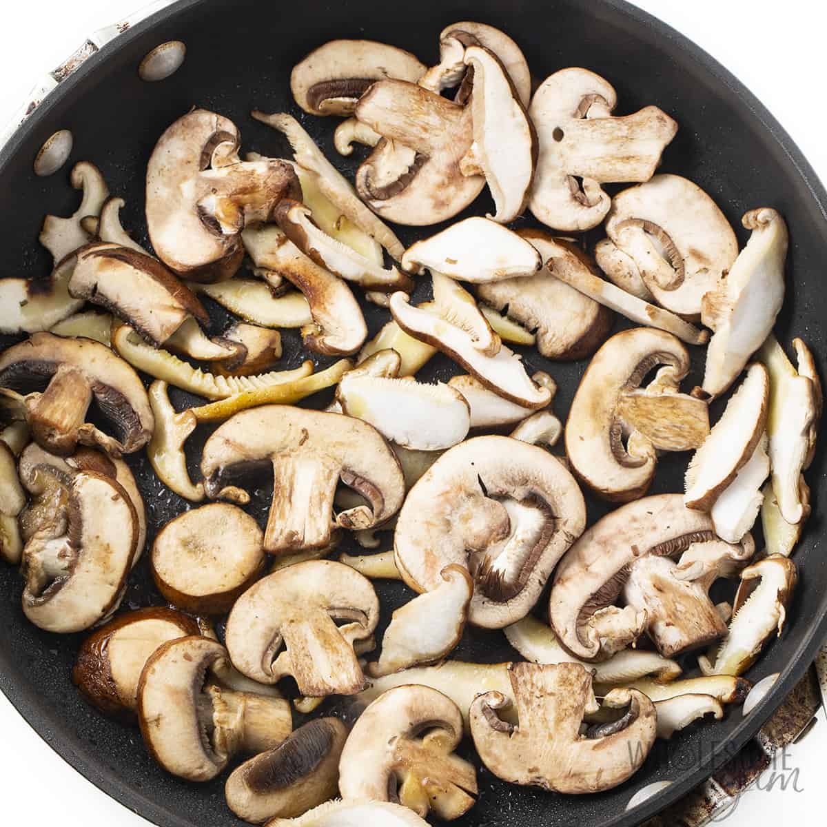First batch of mushrooms in pan, in a single layer.
