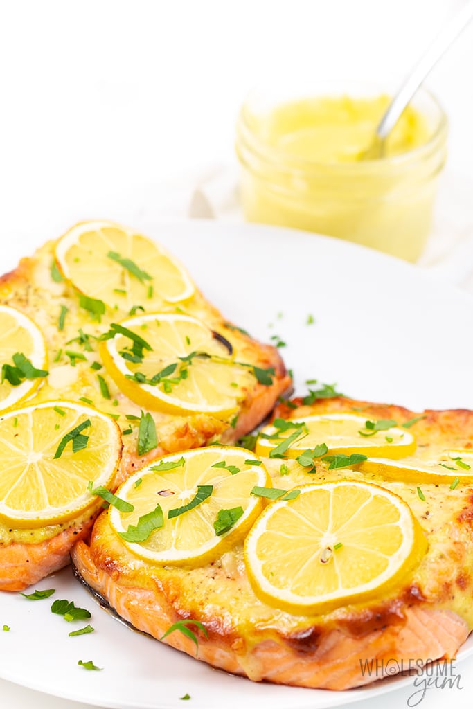 baked salmon fillet with mayo, lemon slices, and parsley
