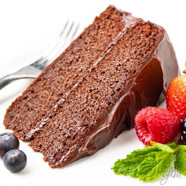 Slice of chocolate cake next to berries