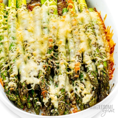 Baked asparagus with parmesan in a baking dish.