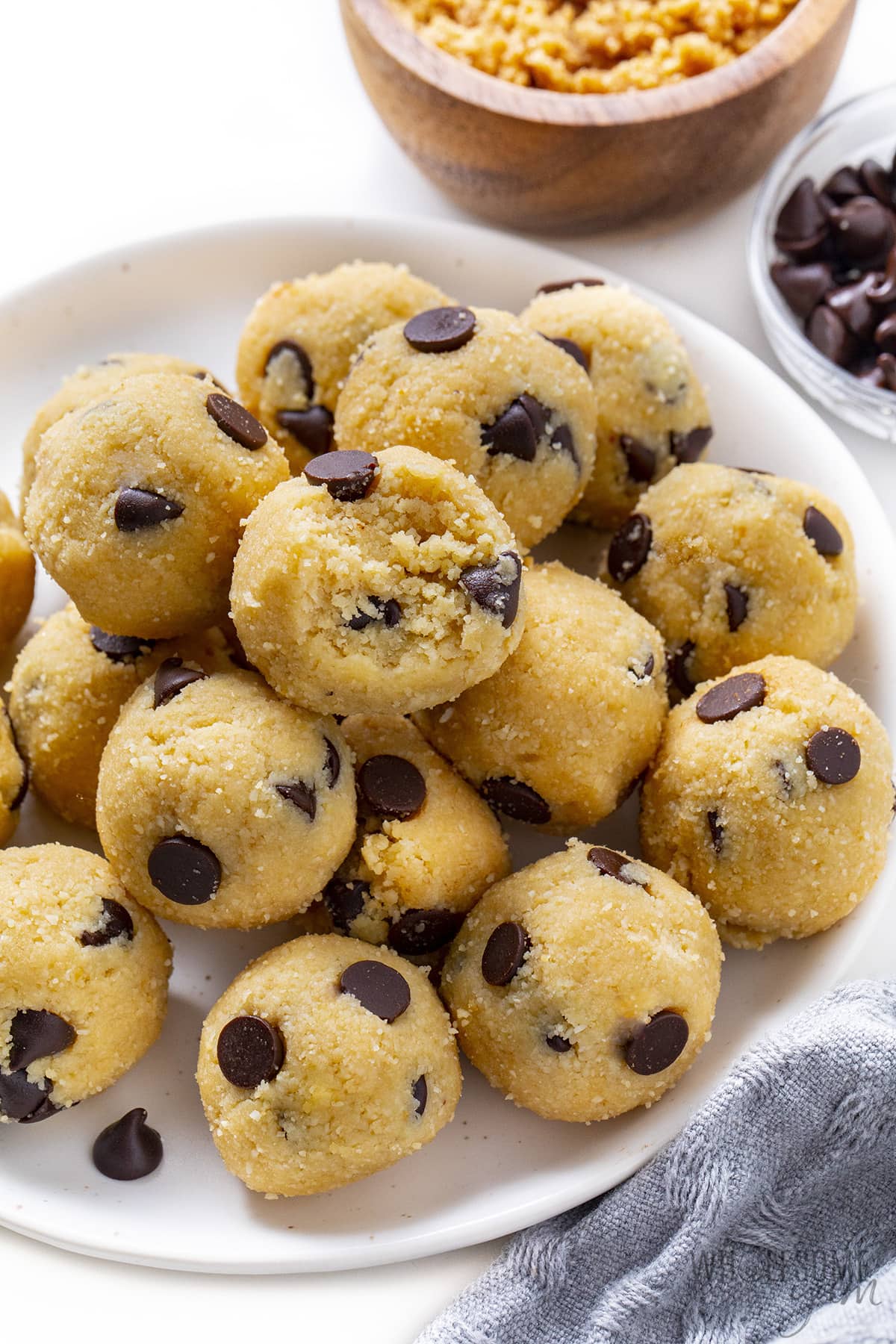 Sugar-free cookie dough bites on a serving platter, with a bite taken out.