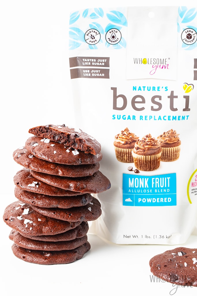 Stacked chocolate almond butter cookies with bag of Besti sweetener