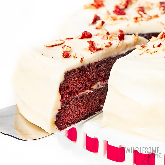Taking out a slice of sugar-free red velvet cake with a spatula