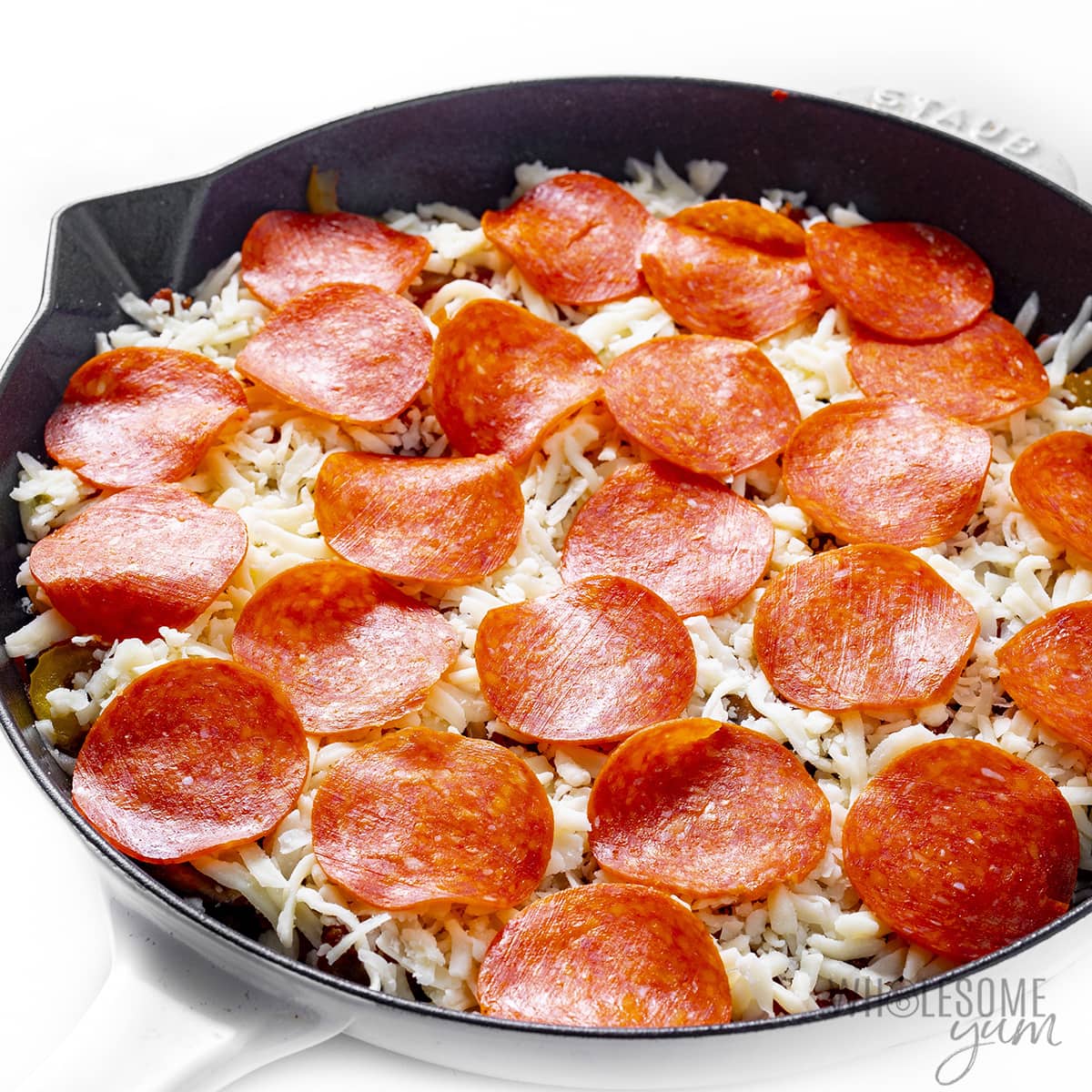 Pizza toppings added to crustless skillet pizza.