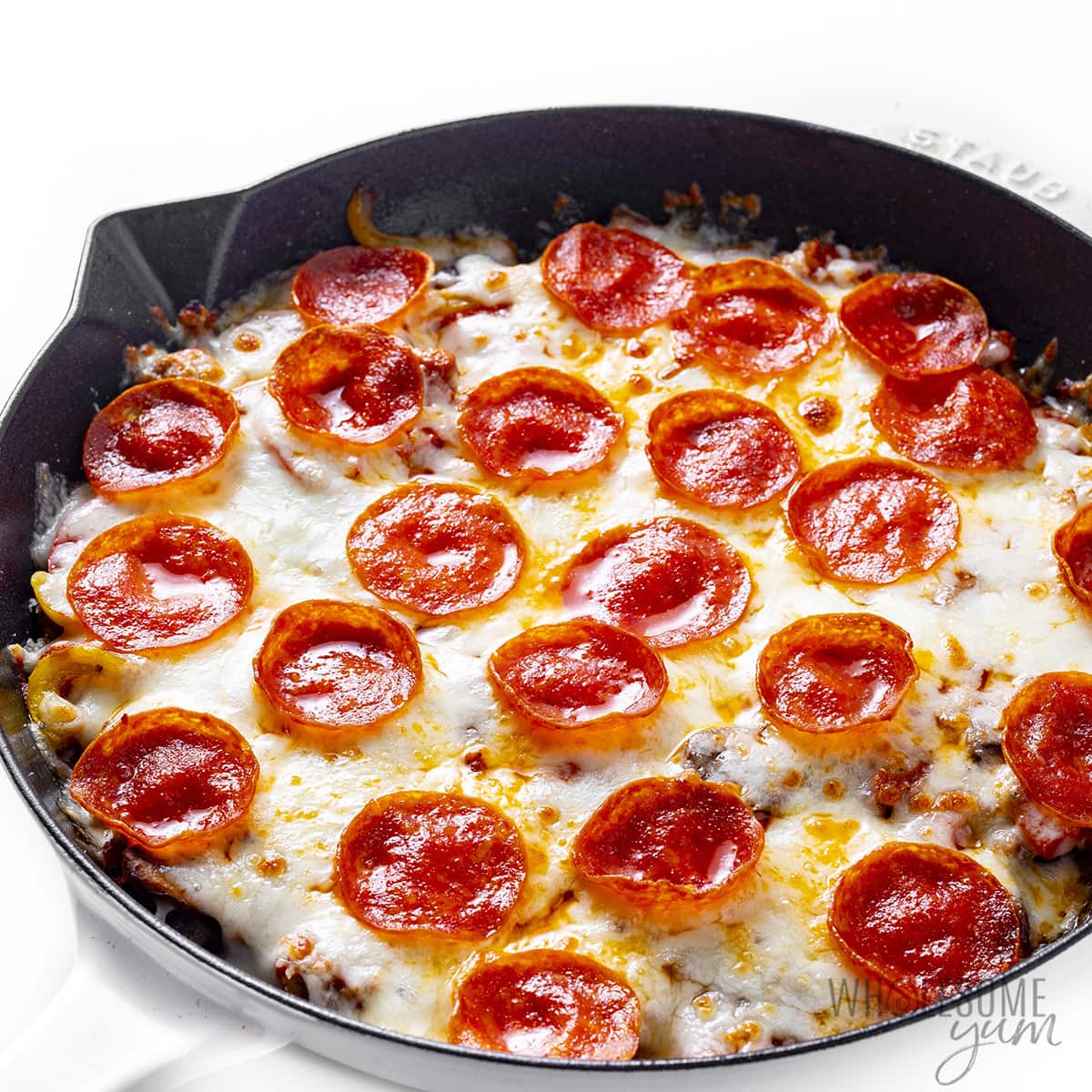 Baked pizza without crust in a skillet.