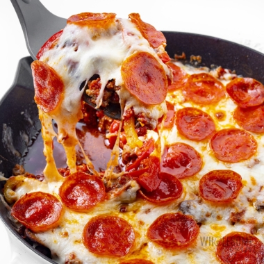 Crustless pizza lifted out of a pan.