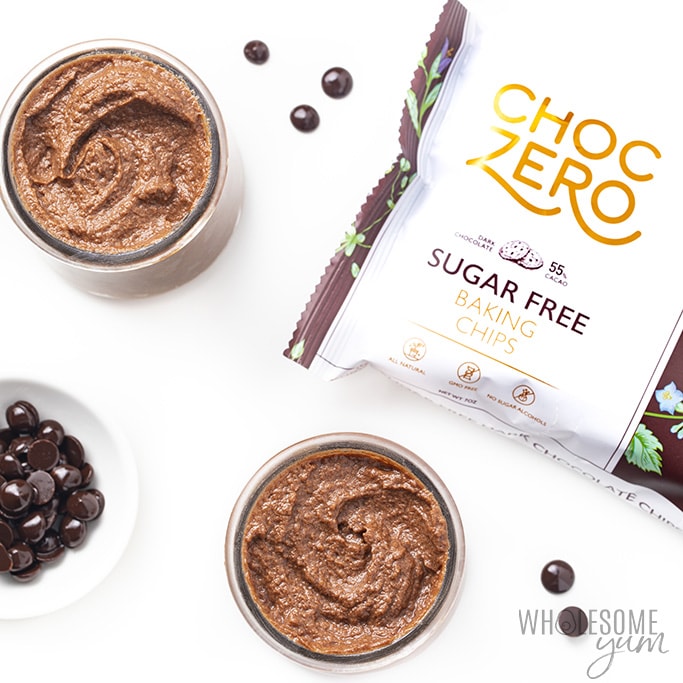 Divide the low carb chocolate mousse into small jars with scattered chocolate chips and a bag of chips nearby