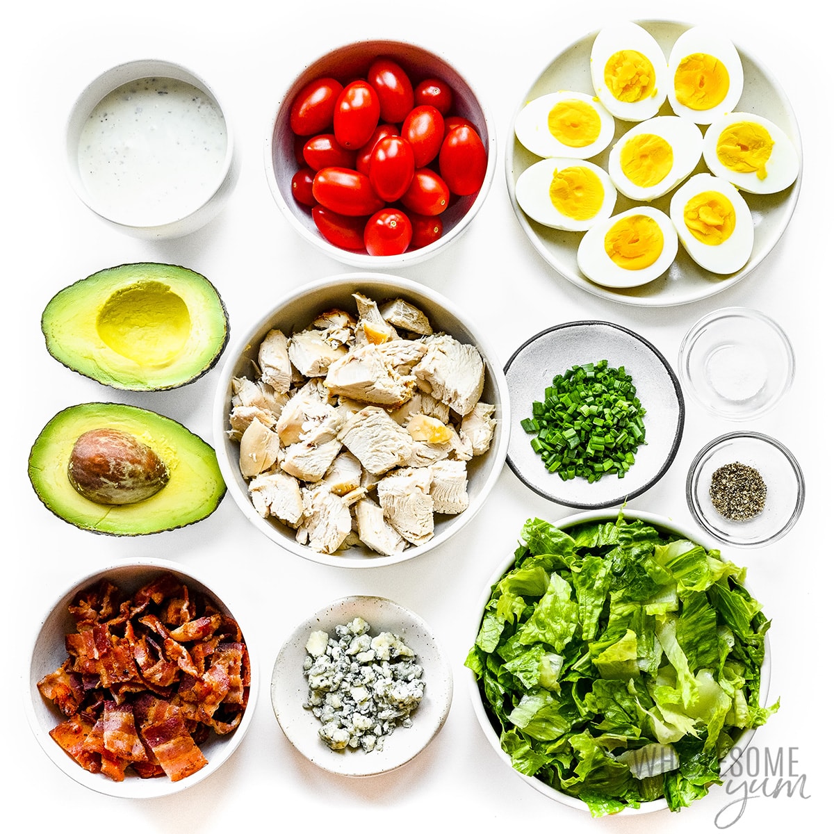 Cobb salad recipe ingredients measured out in bowls.