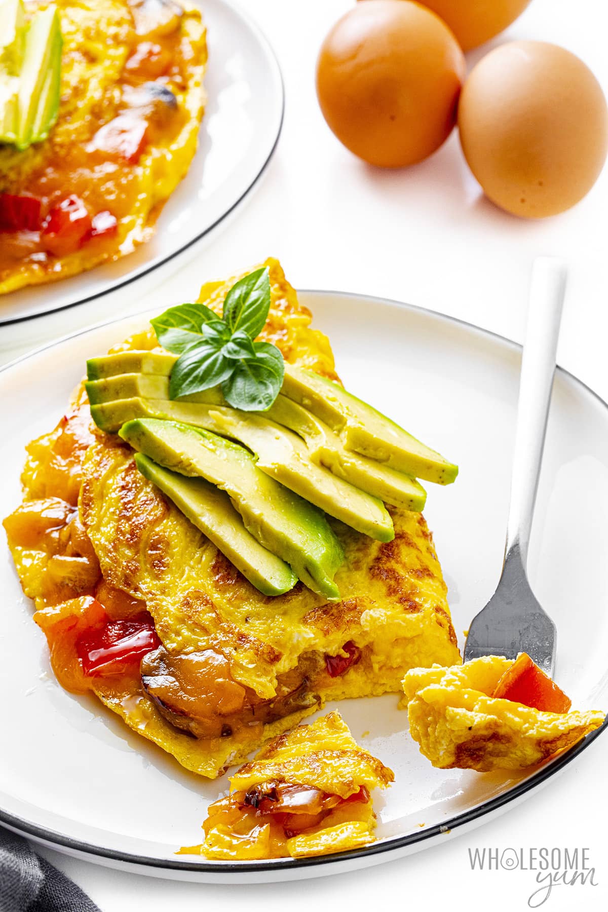 Omelette recipe with a bite on a fork.