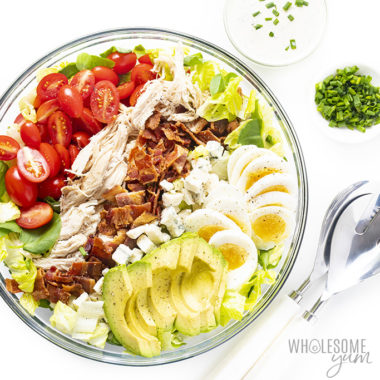 Easy cobb salad dressing recipe in a bowl with ranch dressing, servers, and chives