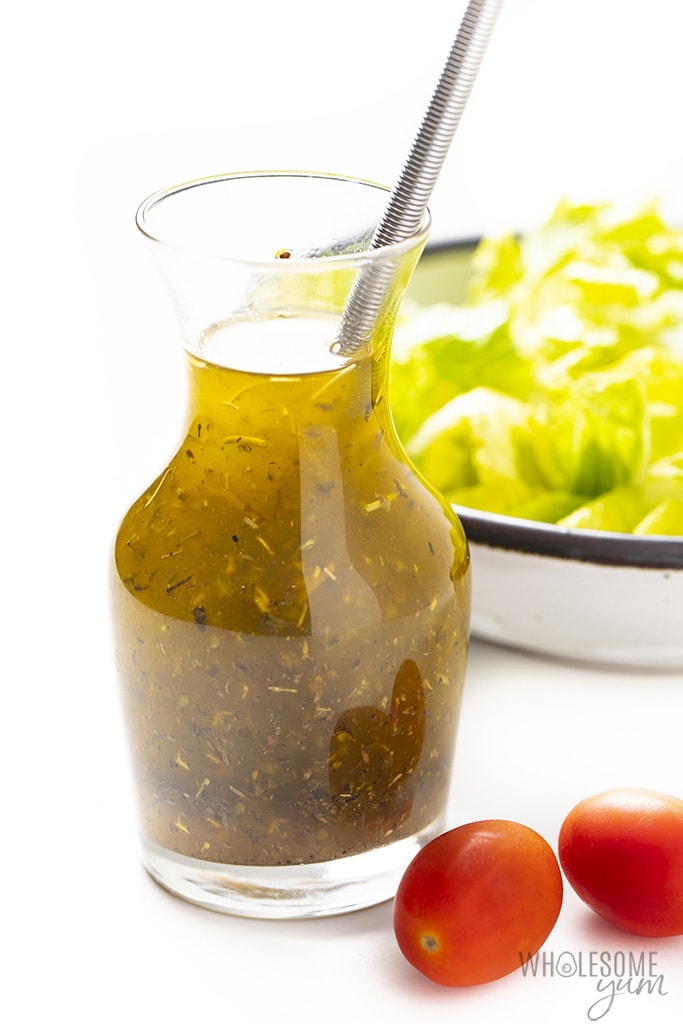 Easy Italian dressing recipe in a small bottle with cherry tomatoes and lettuce