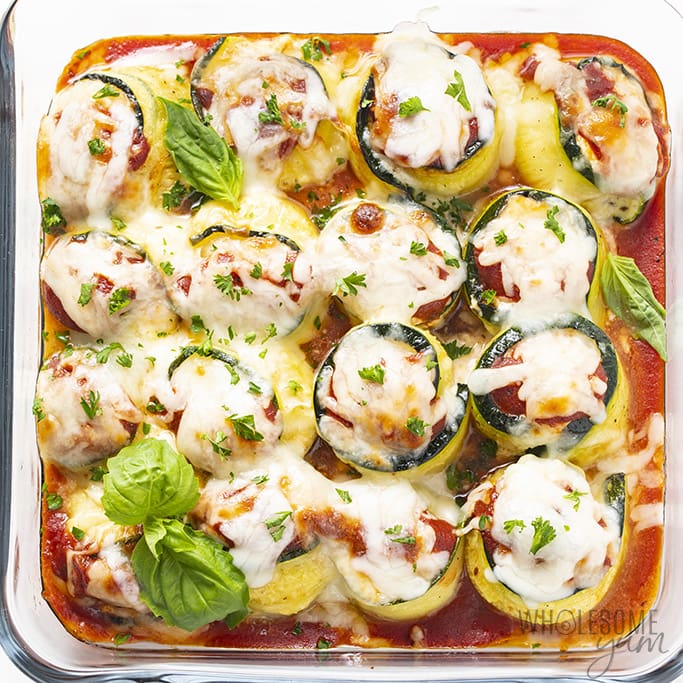 Baked zucchini lasagna rolls with fresh basil on top