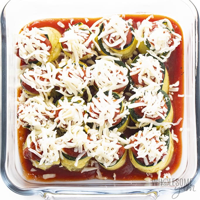 zucchini rolls with marinara and shredded mozzarella on top
