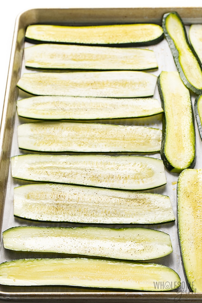 zucchini cut into slices on sheet pan