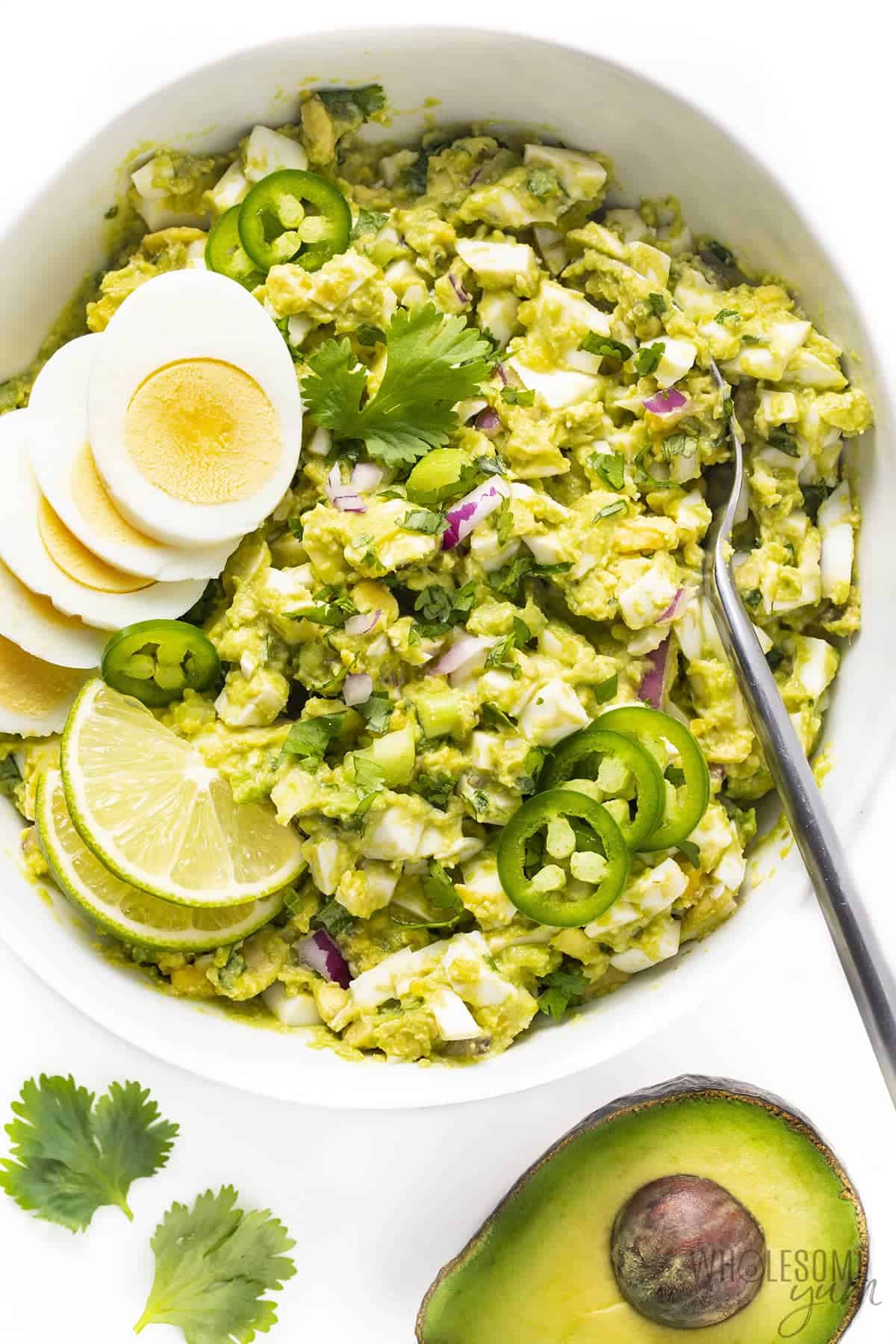 Avocado egg salad recipe with garnishes.