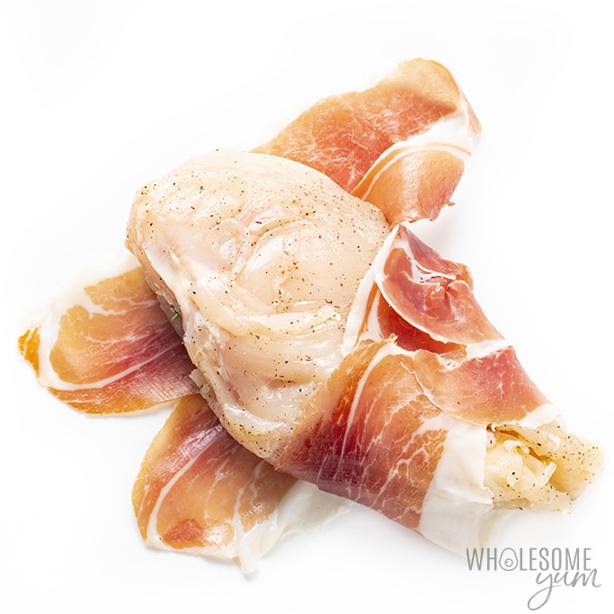 Overhead view of prosciutto wrapped stuffed chicken