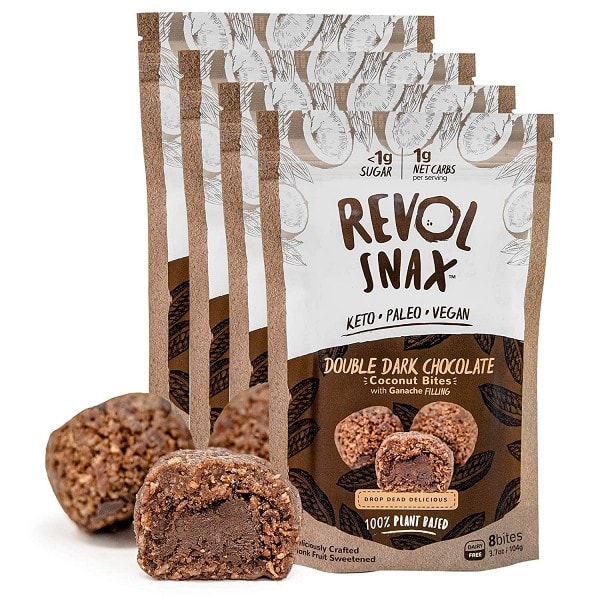Bags of Revol Snax coconut bites with unwrapped coconut bites in foreground