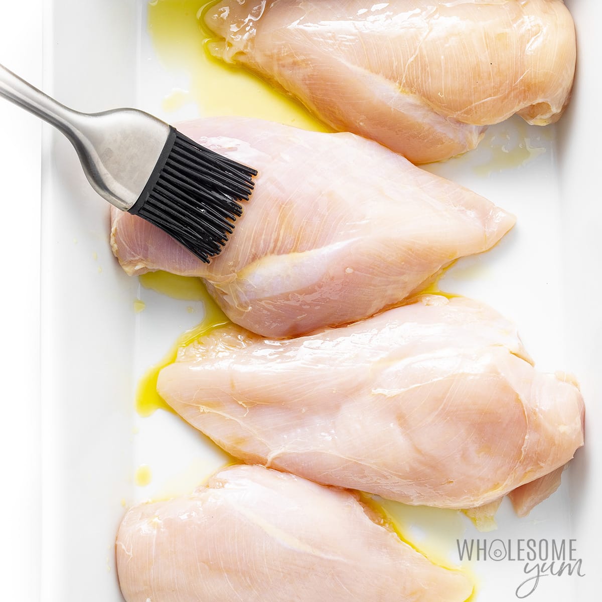 Chicken breasts basted with oil.