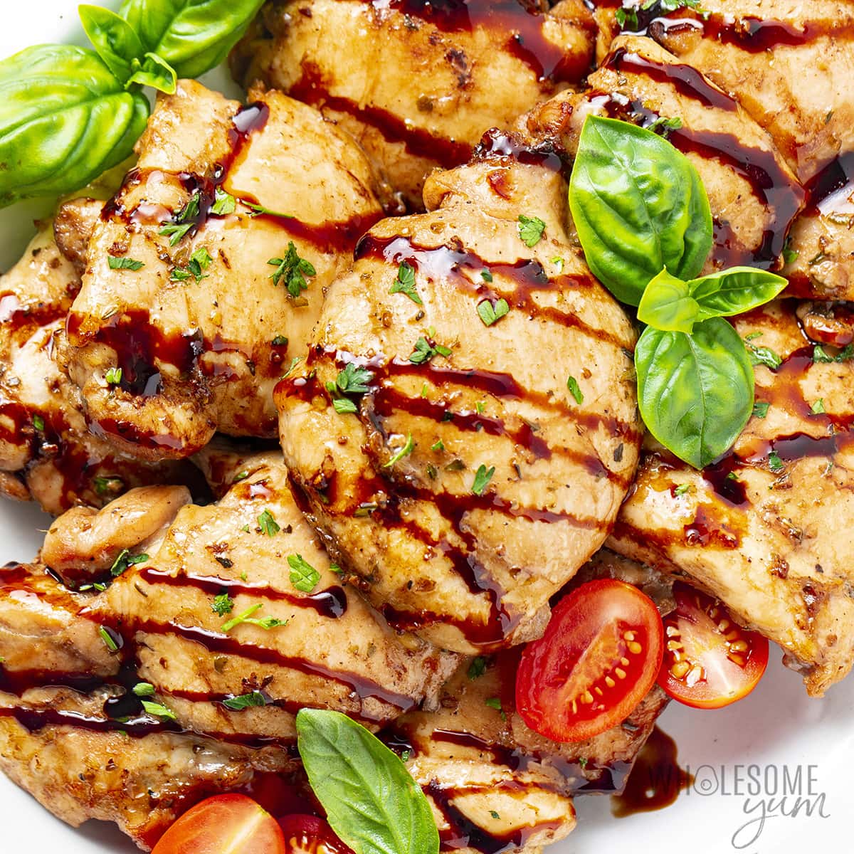 Balsamic chicken with glaze and fresh basil.