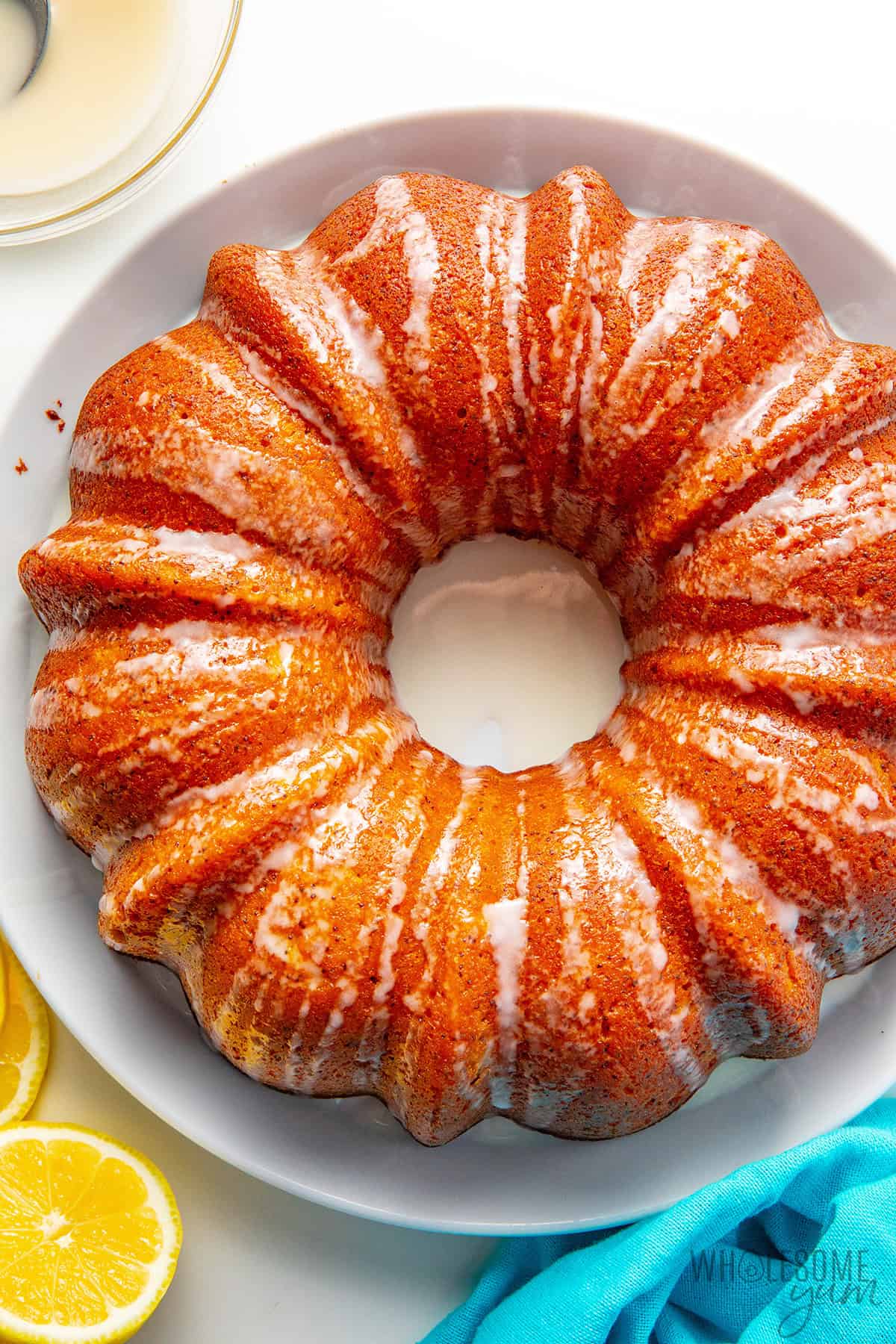 Baked and cooled lemon poppy seed bundt cake drizzled with glaze.