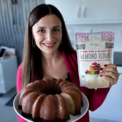 Maya holding lemon bundt cake and a bag of Wholesome Yum Almond Flour.