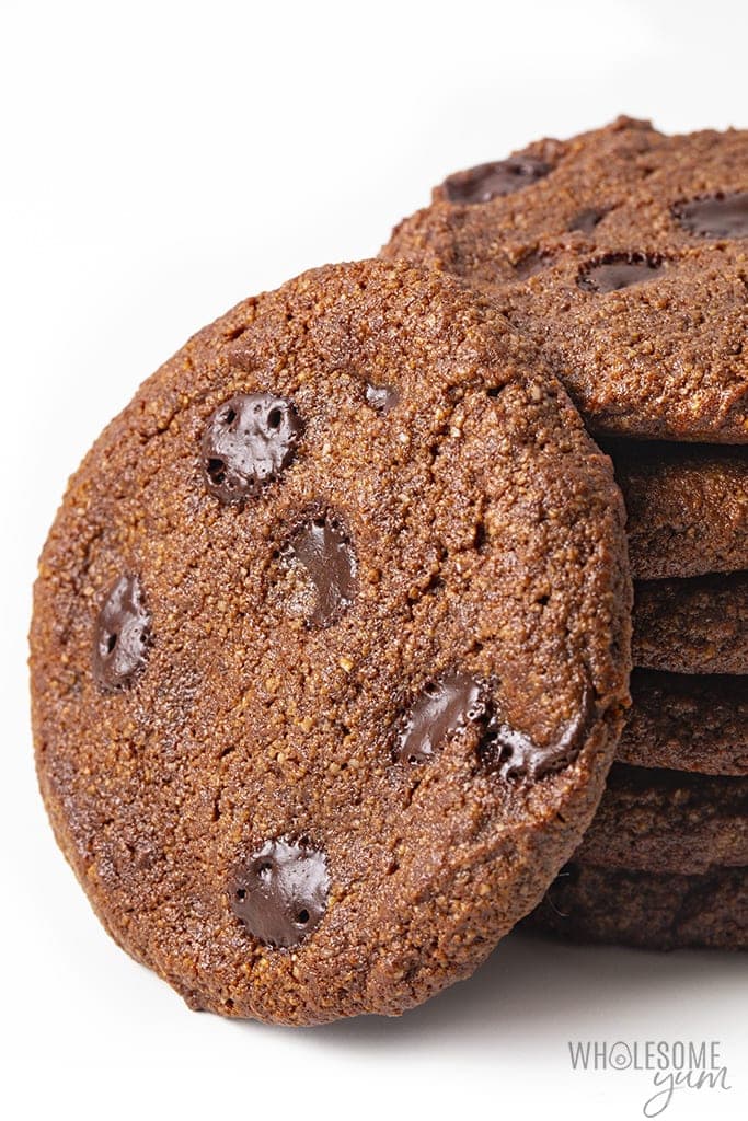Side view of stacked chocolate cookies with one leaning against the stack