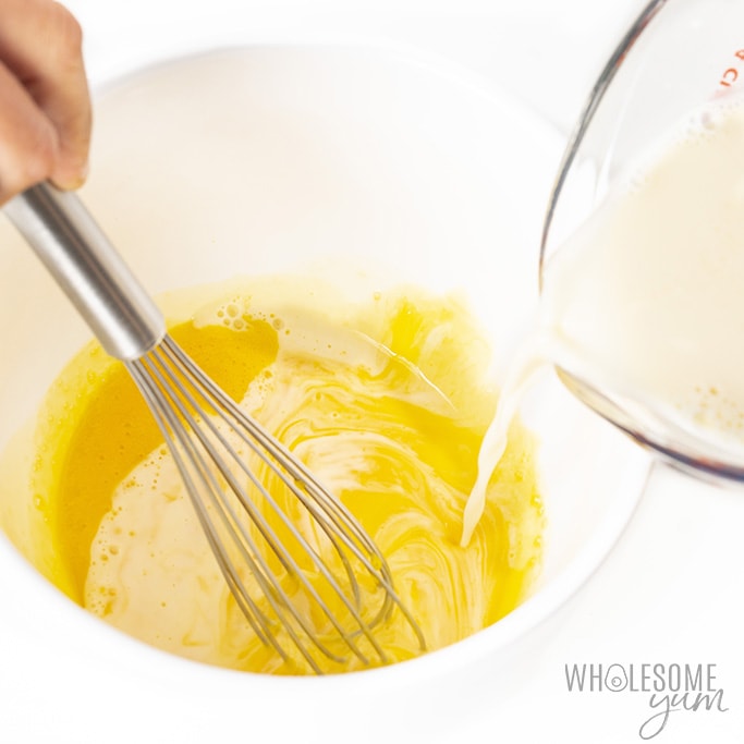 Whisking custard in a bowl with a whisk