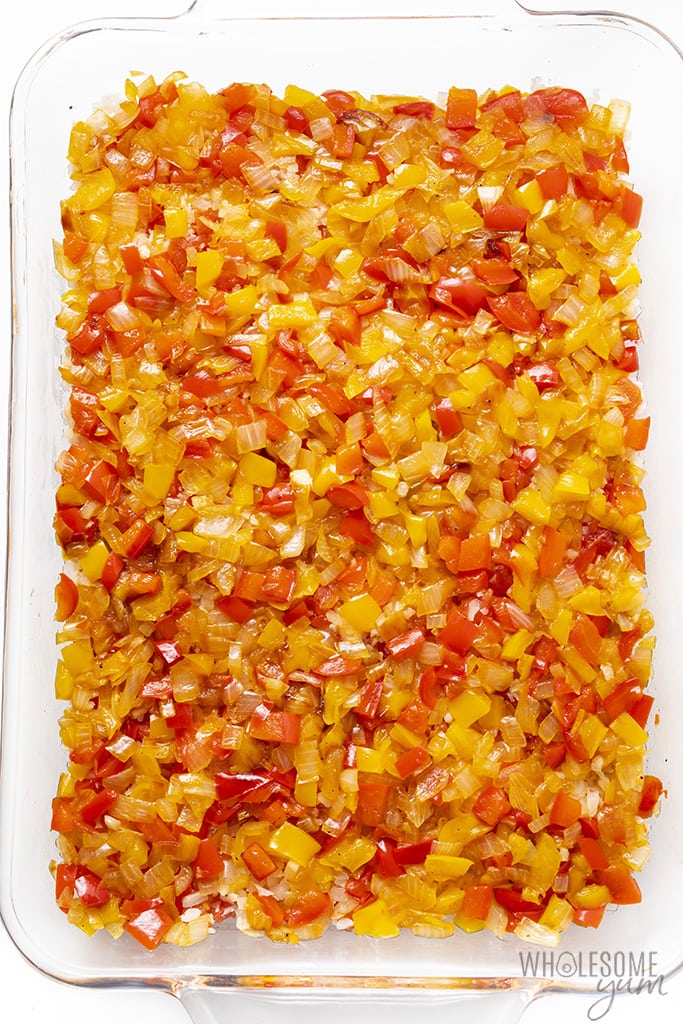 Overhead view of sauteed diced peppers in a casserole dish