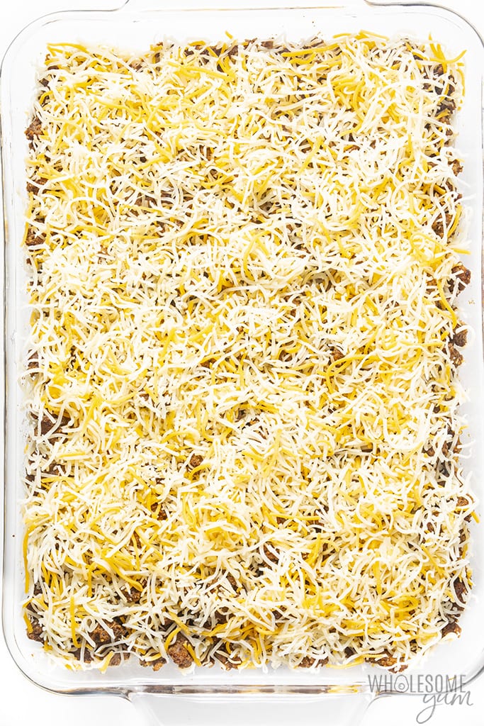 Overhead view of finished casserole with shredded cheese on top before cooking