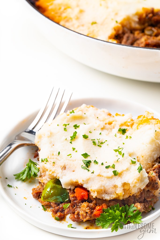 Healthy shepherd's pie on a plate with parsley and a fork