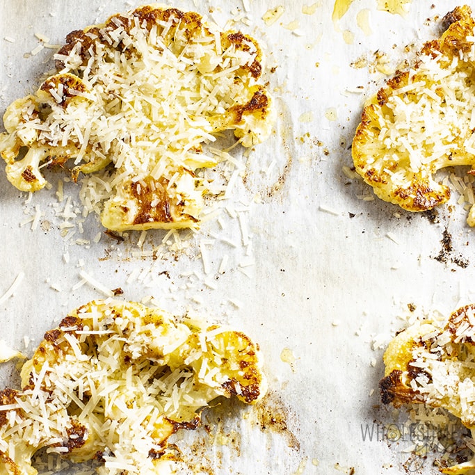 Overhead view of roasted cauliflower steaks on a pan
