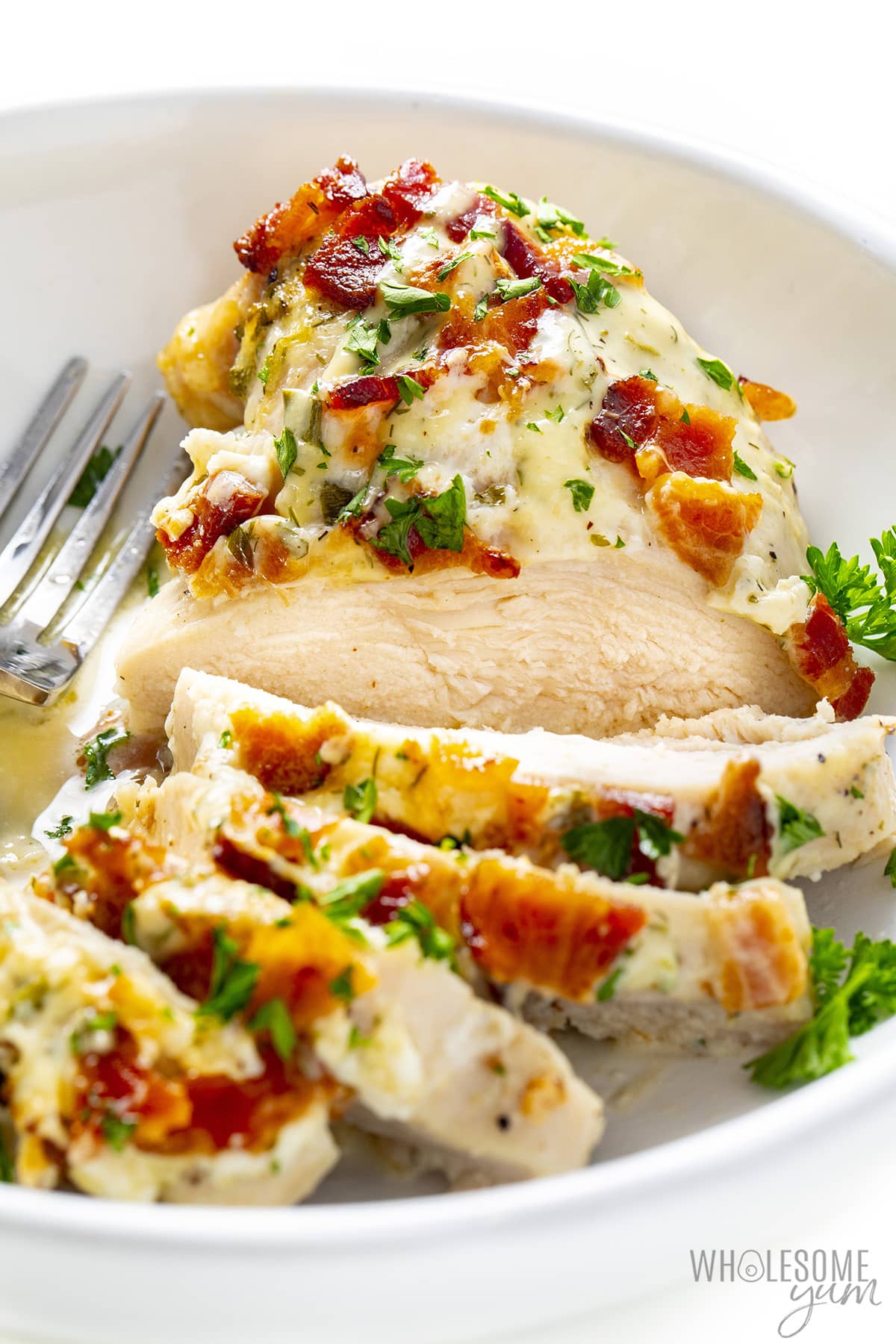 Slice creamy ranch chicken thinly with a fork.