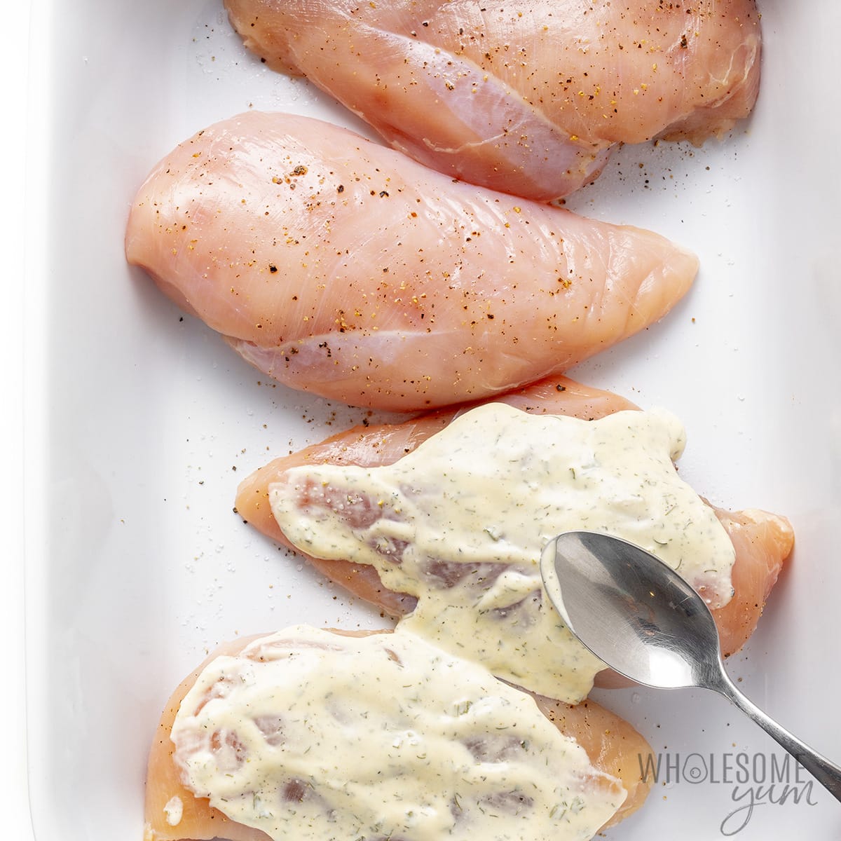 Season the chicken with salt and pepper and top with ranch dressing.
