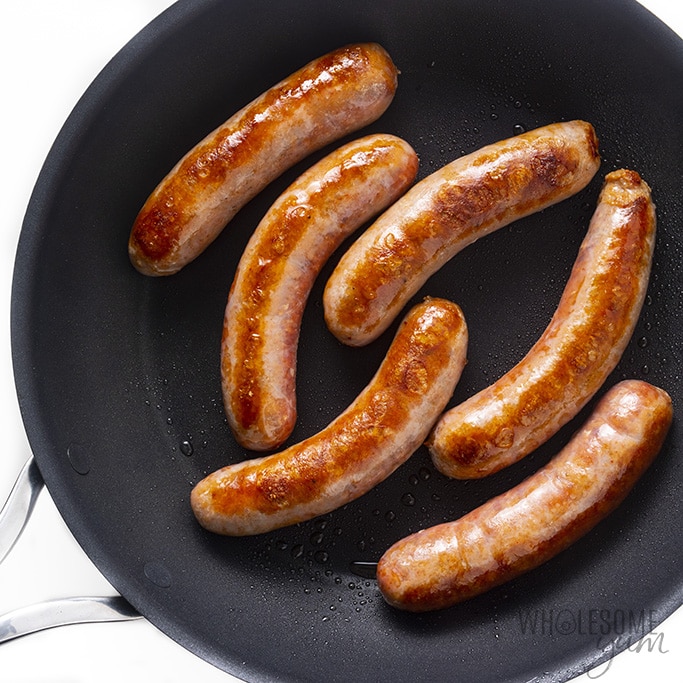 Italian sausage being browned in a skillet.