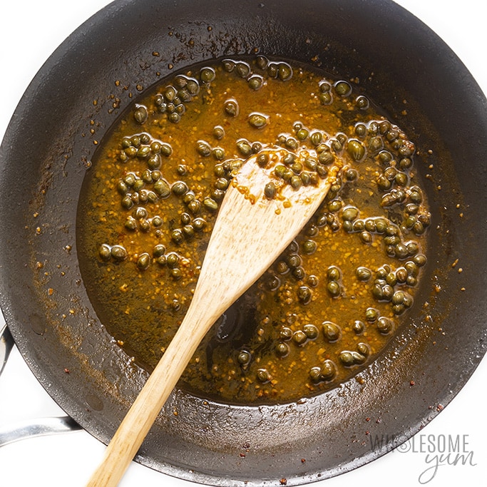 Overhead view of healthy veal scallopini sauce being cooked in a skillet