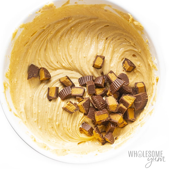 Overhead view of keto cheesecake batter with chopped peanut butter cups