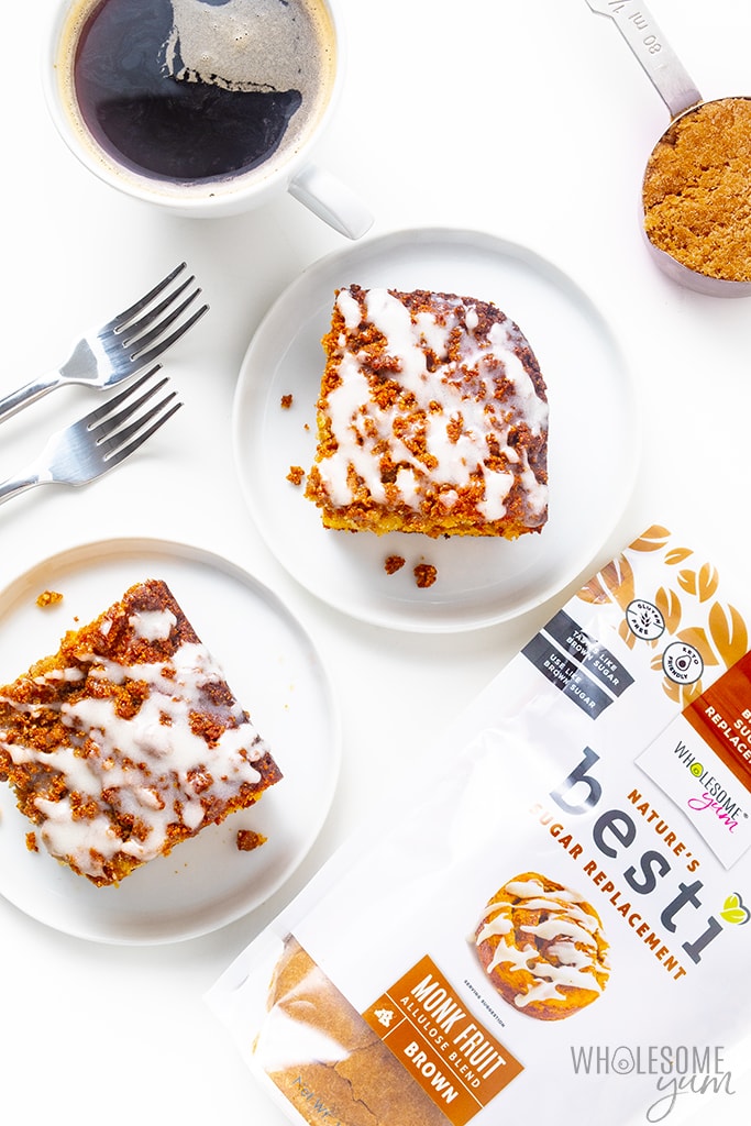 2 slices of almond flour coffee cake on plates with a cup of coffee, forks, and Besti Brown
