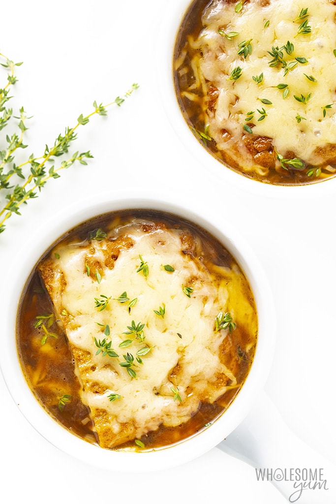 Low carb French onion soup in bowls with thyme garnish