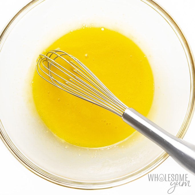 Egg yolks for keto coconut cream pie being whisked in a bowl
